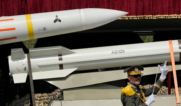 Missiles are carried on a truck as an Iranian army band leader conducts the music band during Army Day parade at a military base in northern Tehran, Iran, Wednesday, April 17, 2024. (AP)