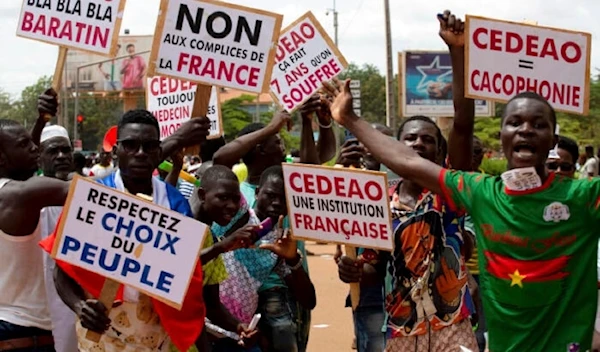 Protest against France and the West African regional bloc known as ECOWAS in the streets of Ouagadougou, Burkina Faso, on October 4, 2022. (AP)