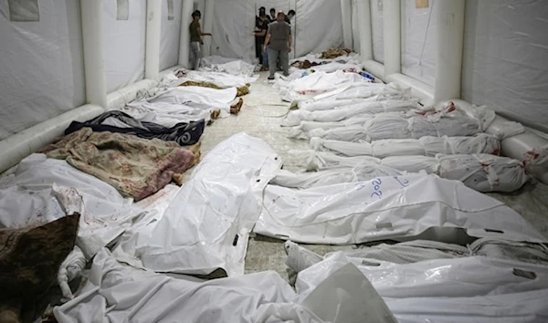 Bodies of Palestinians killed by an airstrike on al-Ahli Baptist Hospital are gathered at the front yard of al-Shifa hospital in Gaza city on Oct. 17, 2023. (AP)