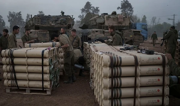 Illustrative: Israeli soldiers from the artillery unit store tank shells in a staging area in southern occupied Palestine, January 1, 2024. (AP)