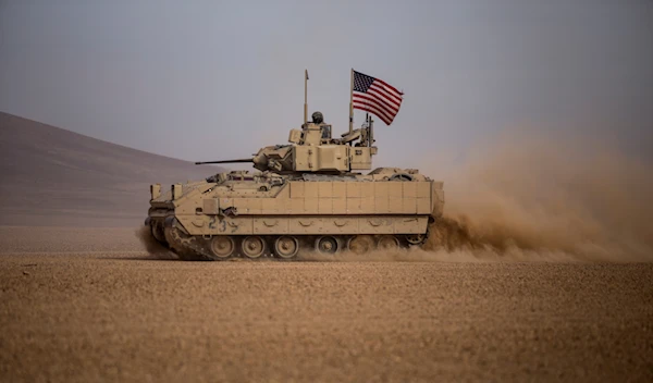 American soldiers drive a Bradley fighting vehicle during a joint exercise with Syrian Democratic Forces at the countryside of Deir Ezzor in northeastern Syria, Dec. 8, 2021. (AP)