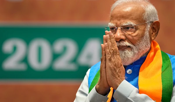 Indian Prime Minister Narendra Modi greets during the unveiling of his Hindu nationalist Bharatiya Janata party’s election manifesto in New Delhi, India, April 14, 2024. (AP)