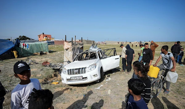 People inspect the site where World Central Kitchen workers were killed in Deir al-Balah, Gaza Strip, Tuesday, April 2, 2024 (AP Photo/Abdel Kareem Hana)