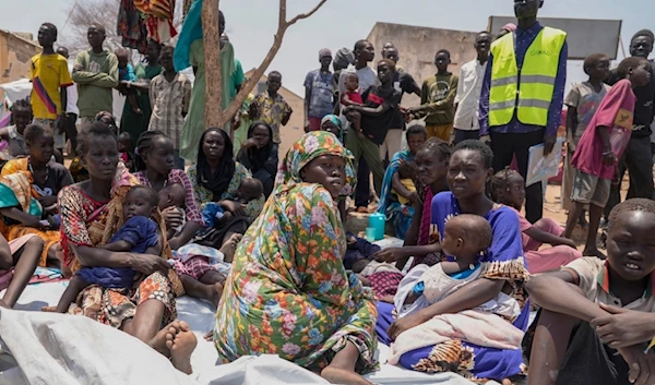 South Sudanese who fled from Sudan sit outside a nutrition clinic at a transit center in Renk, South Sudan, on May 16, 2023 (AP)