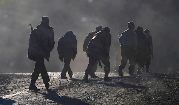 Nov. 8, 2020 file photo, ethnic Armenian soldiers walk along the road near the border between Nagorno-Karabakh and Armenia (AP)