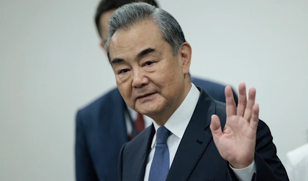 Chinese Foreign Minister Wang Yi waves before the start of his bilateral meeting with Indonesian Foreign Minister Retno Marsudi in Jakarta, Indonesia, Thursday, April 18, 2024. (AP)