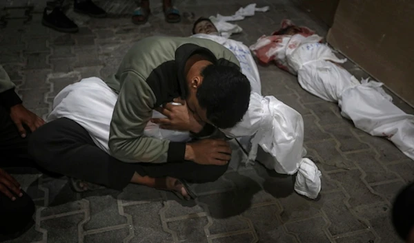 A Palestinian youth mourns his relative killed in the Israeli bombardment of the Gaza Strip, at the morgue of the Kuwaiti Hospital in Rafah refugee camp, southern Gaza Strip, April 20, 2024. (AP)