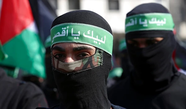 Masked Hamas militants wave their national flags during a protest against the Mideast plan announced by U.S. President Donald Trump, in Gaza City, Feb. 21, 2020. (AP)