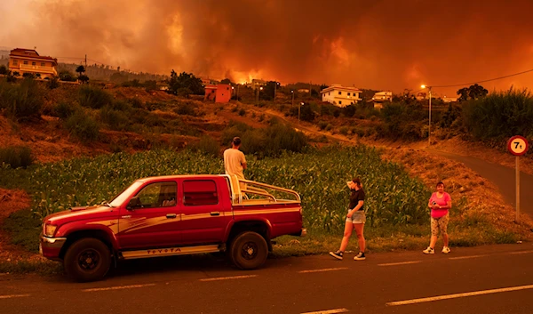 Residents try to reach their houses in Benijos village as a wildfire advances in La Orotava in Tenerife, Canary Islands, Spain, Aug. 19, 2023.(AP)