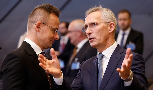 NATO Secretary General Jens Stoltenberg with Hungary's Foreign Minister Peter Szijjarto during a meeting at NATO headquarters in Brussels, Wednesday, April 3, 2024. (AP)