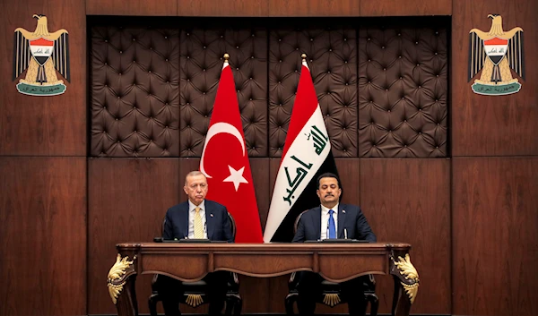 Iraq's Prime Minister Mohammed Shia al-Sudani, right, and Turkey's President Recep Tayyip Erdogan sit together during their meeting in Baghdad, Iraq, Monday April 22, 2024. (Pool via AP)