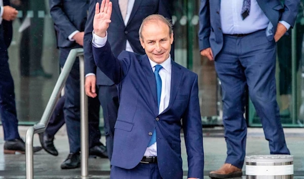 Ireland's foreign minister Michael Martin waving his hands at supporters in 2020. (AFP)