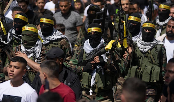 Al-Aqsa Martyrs Brigades freedom fighters, the military wing of Fatah Movement, attend the funeral of Palestinians Jihad Sami and Odai Shami in the West Bank city of Nablus, Saturday, May 6, 2023. (AP)