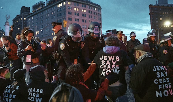 Police arrest protesters as they block traffic during a pro-Palestinian demonstration demanding a permanent cease-fire in Gaza, near the home of Sen. Chuck Schumer in the Brooklyn borough of New York, on April 23, 2024. (AP)