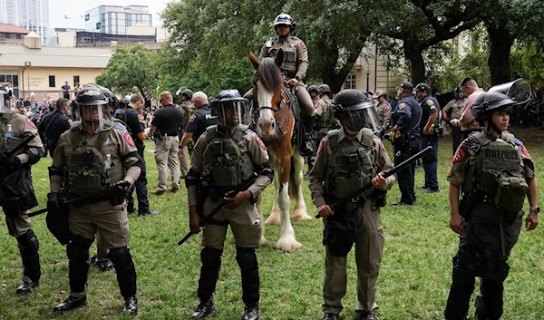 Texas State Troopers and other law enforcement personnel monitor the scene as pro-Palestinian students protest against Israeli genocide, on the campus of the University of Texas in Austin on April 24, 2024. (AFP)