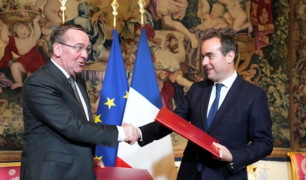 French Defense Minister Sebastien Lecornu , right, and his German counterpart Boris Pistorius shakes hands after signing an agreement in Paris Friday, April 26, 2024. (AP)