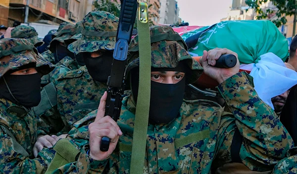 Islamic Group members carry the body of their comrade Mohammad Riad Mohyeldin, who was killed in an Israeli strike, during his funeral procession in Beirut, Lebanon, March 12, 2024 (AP)