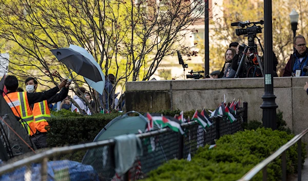 People block views from members of the media at pro-Palestine demonstration encampment at Columbia University, April 26, 2024, in New York (AP)