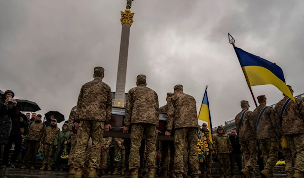 Honour guards carry the coffin of Ukrainian army paramedic Nazarii Lavrovskyi, 31, killed in the war, during his funeral ceremony at Independence square in Kyiv, Wednesday, April 24, 2024. (AP)