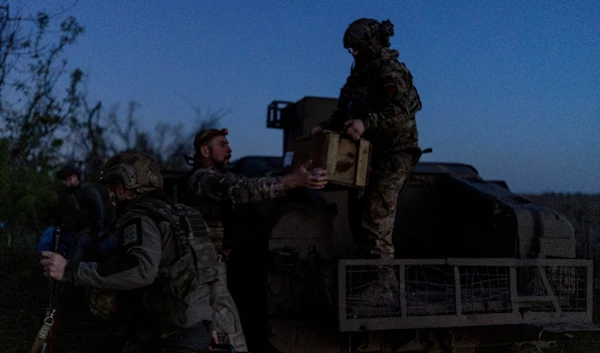 Ukrainian servicemen from Code 9.2 unit unloaded ammunition from Humvee at the frontline positions, few kilometres from Bakhmut, Donetsk region, Ukraine, Tuesday, April 23, 2024. (AP)