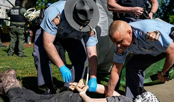 Officers detain a protester at Emory University on 26 April 2024. (AP)