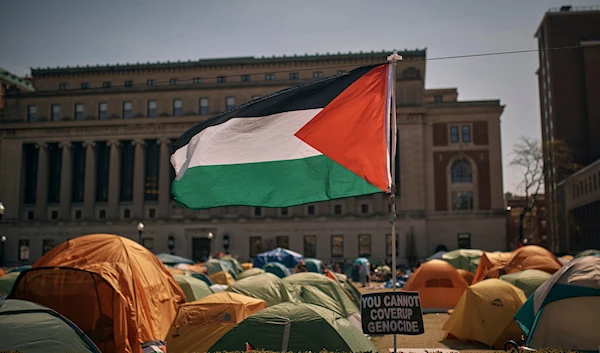 People listen to a speaker at a pro-Palestinian encampment, inside the campus of Columbia University, April 28, 2024, in New York (AP)