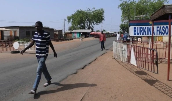 A man walks next to a Burkina Faso sign (AFP)