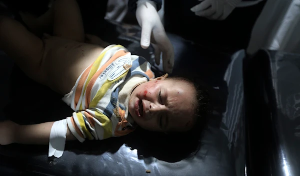 Palestinian medics treat a wounded child in the Israeli bombardment of the Gaza Strip at the Kuwaiti Hospital in Rafah refugee camp on April 19, 2024. (AP)