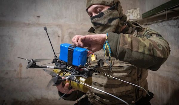 A Ukrainian soldier of the 71st Jaeger Brigade prepares a FPV drone at the frontline, near Avdiivka, Donetsk region, Ukraine, Friday, March 22, 2024. (AP)