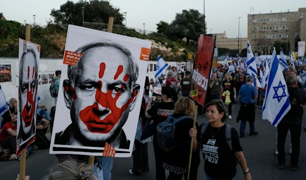 Israeli occupation settlers take part in a protest against Israeli occupation Prime Minister Benjamin Netanyahu's government outside of the Knesset, in occupied al-Quds, occupied Palestine, Sunday, March 31, 2024. (AP)