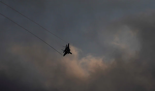 An Israeli Air Force F-15 jet fighter maneuvers over northern occupied Palestine on the border area with Lebanon, February 27, 2024 (AP)