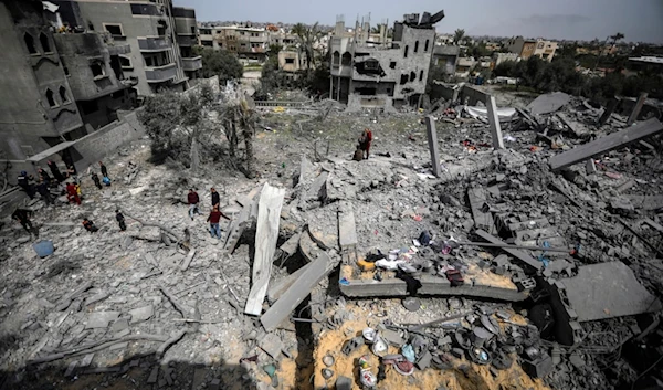 Palestinians inspect the damage to a residential building for the Moussa family after an Israeli airstrike in the Maghazi refugee camp, central Gaza Strip, Friday, March 29, 2024. (AP)