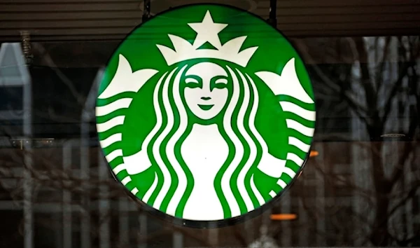 A file photo shows a Starbucks logo sign in the windows of one of the chain’s cafes in US. (AP)