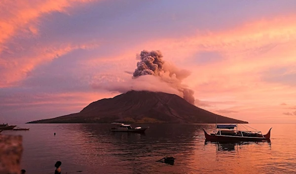 Mt Ruang erupting in Sitaro, North Sulawesi, sending a tower of ash spewing into the sky (AFP)