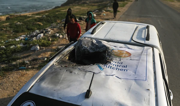 Palestinians inspect a vehicle with the logo of the World Central Kitchen wrecked by an Israeli airstrike in Deir al Balah, Gaza, Tuesday, April 2, 2024. (AP)