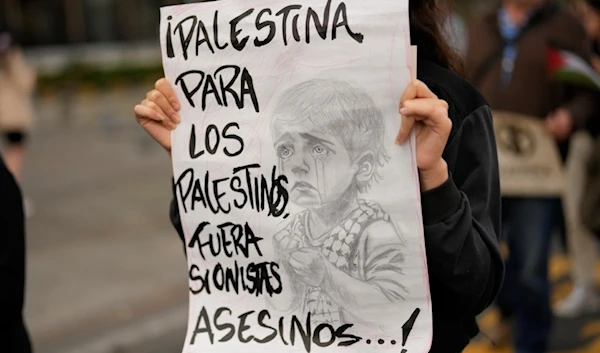 A girl carries a sign that reads in Spanish "Palestine for Palestinians. Murdering Zionists Out!", during a march in solidarity with the Palestinian people, in Bogota, Colombia, Nov. 29, 2023. (AP)