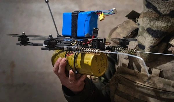 A Ukrainian soldier of the 71st Jaeger Brigade prepares a FPV drone at the frontline, near Avdiivka, Donetsk region, Ukraine, Friday, March 22, 2024. (AP Photo/Efrem Lukatsky)