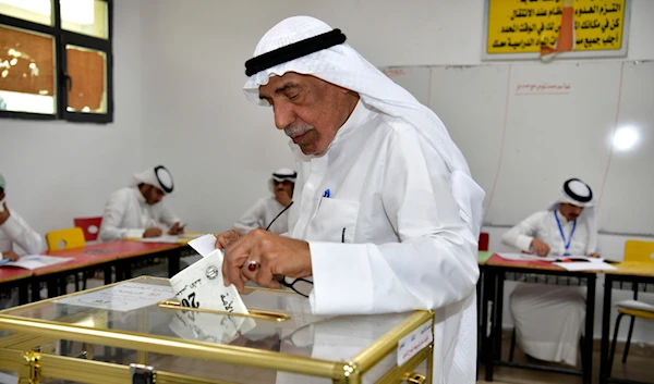 A man casts his vote for the National Assembly elections at Salem Al Nawaf school in Al Riqqa district, Kuwait, Thursday, April 4, 2024. (AP)