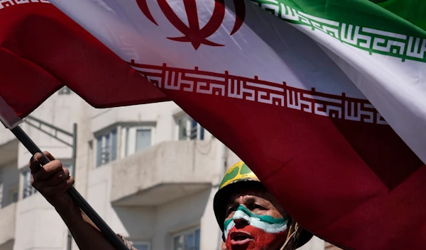 A man chants slogans as he waves the Iranian flag in the annual rally to mark Quds Day, or Jerusalem Day, in support of Palestinians, in Tehran, Iran, Friday, April 5, 2024. (AP)