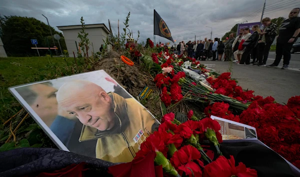 A portrait of the owner of private military company Wagner Group Yevgeny Prigozhin lays at an informal memorial next to the former 'PMC Wagner Centre' in St. Petersburg, Russia on Aug. 24, 2023. (AP)