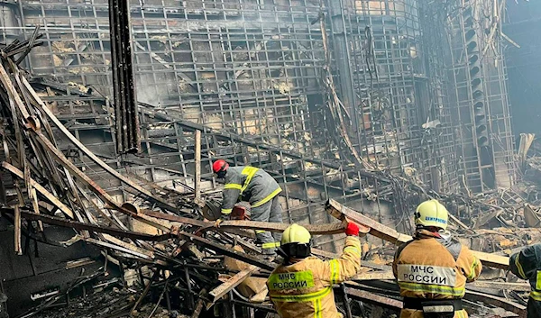 In this photo released by the Russian Emergency Ministry Press Service, Russian Emergency Ministry rescuers work inside the Crocus City Hall in Moscow, Russia, Saturday, March 23, 2024 (AP)