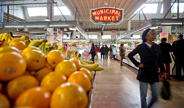 his photo taken Dec. 20, 2013 shows shoppers passing through the Sweet Auburn Curb Market in Atlanta. (ap)