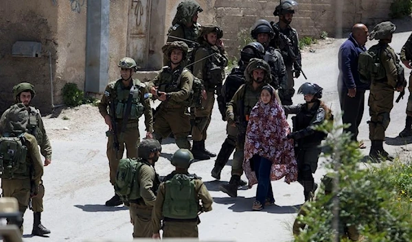 Israeli occupation soldiers arrest a Palestinian women in the village of Ya’bad near the occupied West Bank of Jenin, Palestine, May 12, 2020. (AFP)