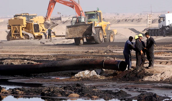 In this Dec. 14, 2011 file photo, workers repair oil pipelines at Rumaila oil fields, near the southern Iraqi city of Basra. (AP)