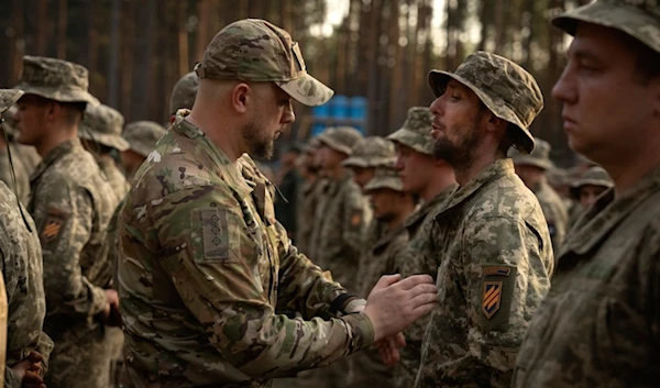 Newly recruited soldiers who mark the end of their training at a military base close to Kyiv, Ukraine, on Sept. 25, 2023 (AP)