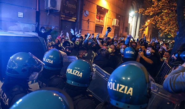 Protesters poured into the streets of Naples where some police vehicles were targeted by demonstrators on October 24, 2020. (AFP)