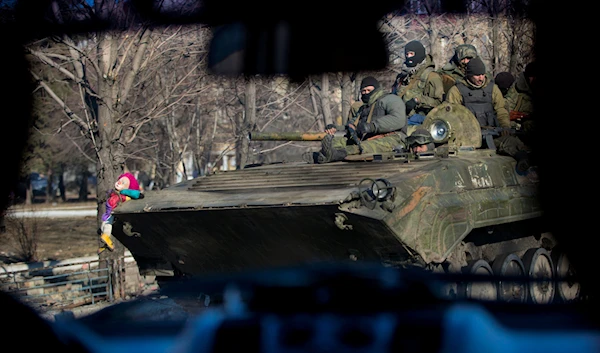 A clown doll is attached to the front of an armored transporter in Debaltseve, Ukraine, Sunday, Feb. 22, 2015.(AP)