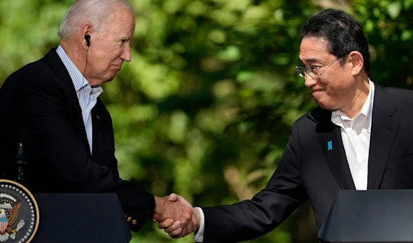 U.S. President Joe Biden, left, shakes hands with Japan's Prime Minister Fumio Kishida during a joint news conference with South Korean President Yoon Suk Yeol, not visible, on Aug. 18, 2023 (AP)