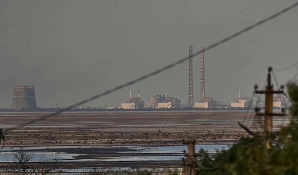 The Zaporizhzhia nuclear power plant, Europe's largest, is seen in the background of the shallow Kakhovka Reservoir after the dam collapse, in Energodar, Russian-occupied Ukraine, June 27, 2023.