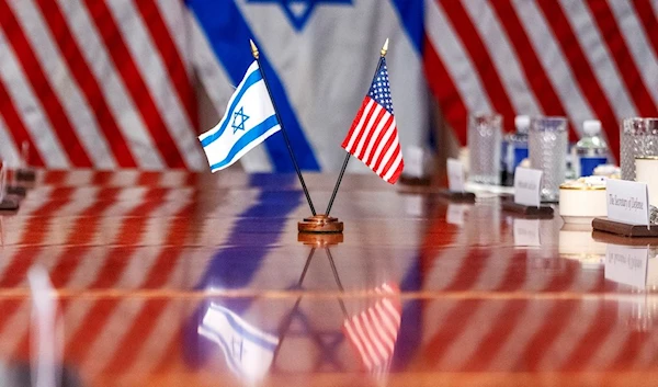 An Israeli and US flag are reflected on a conference table as Defense Secretary Lloyd Austin meets with Israeli Security Minister Yoav Gallant, at the Pentagon, March 26, 2024, in Washington, US. (AP)